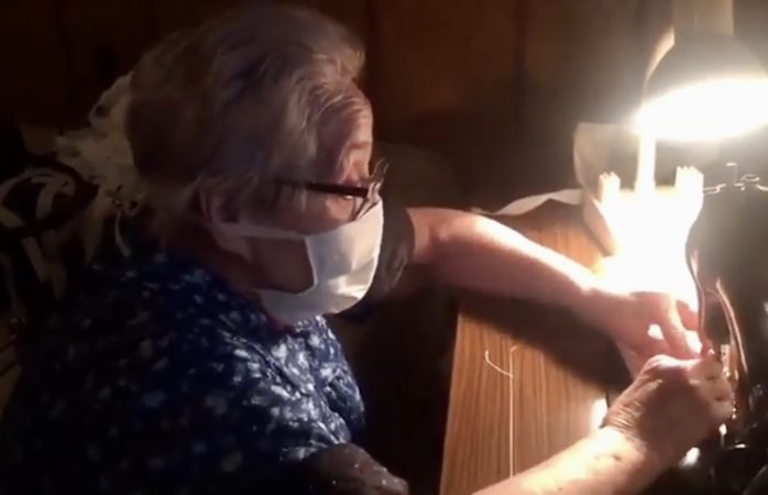 Anciana con párkinson cose cubre bocas para ayudar a hospital